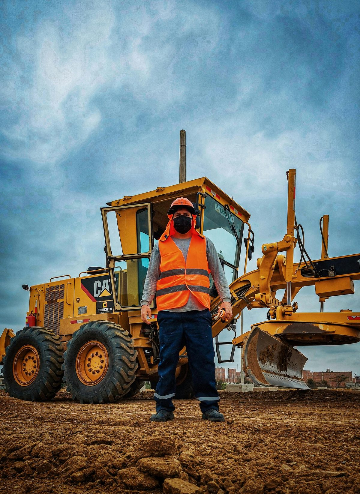 Construction worker in front of heavy machinery
