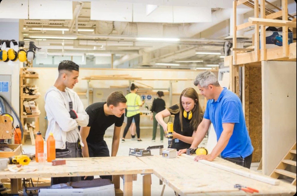 Trainees learning carpentry and tool handling at our training workshop